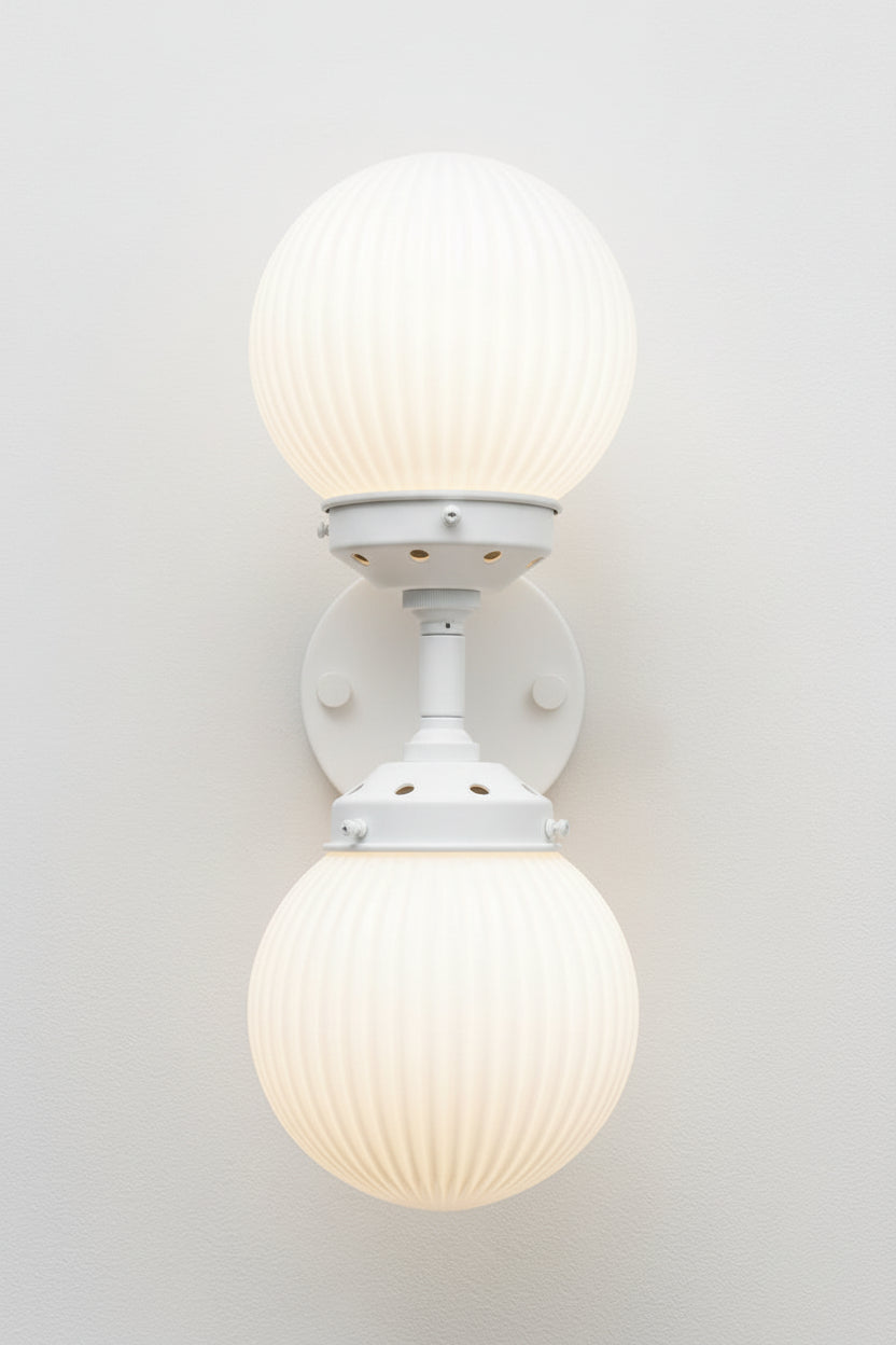 double arm wall sconce with opal shades and white dual sconce
