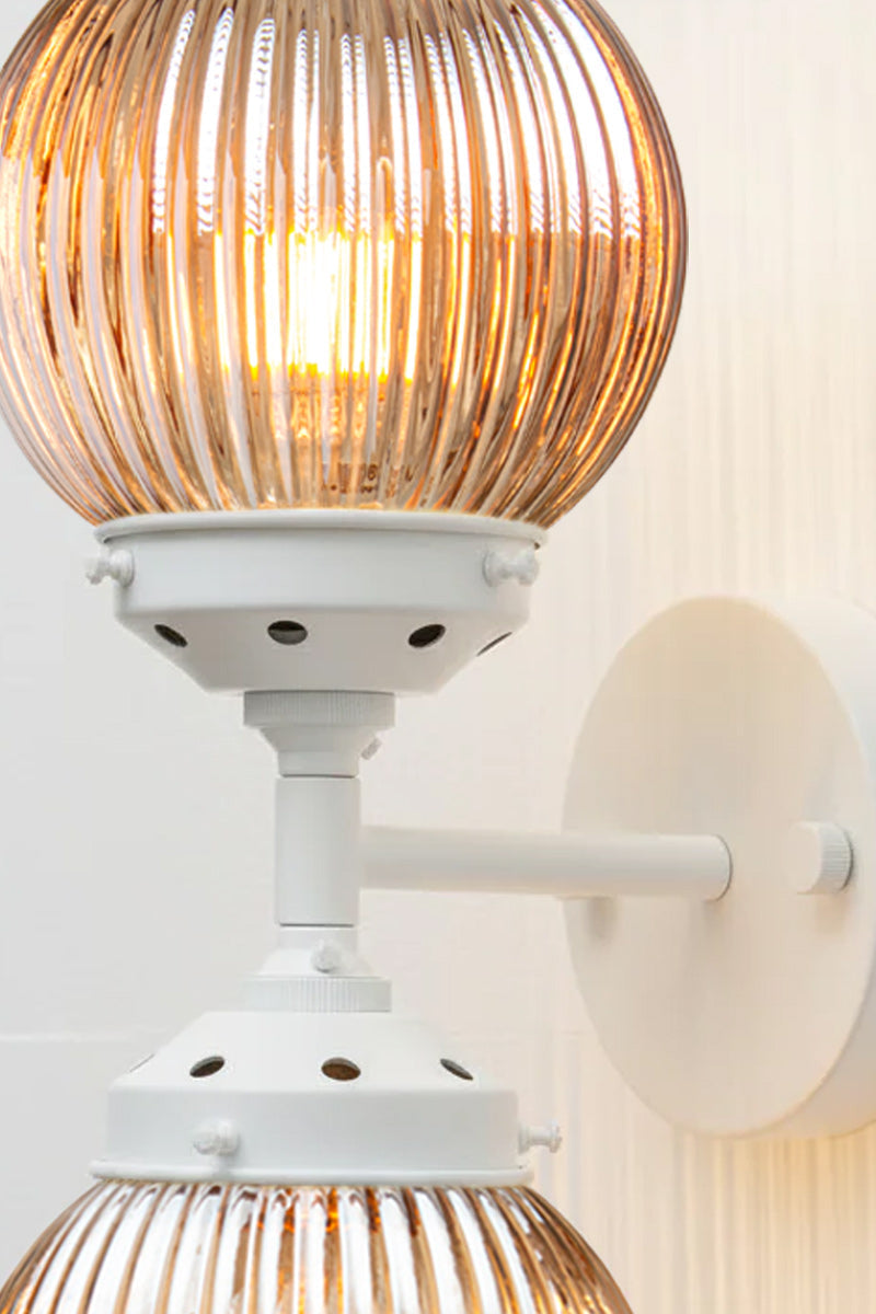 Close up of the Dakota Reeded Glass Double Light in white with dark amber shades.
