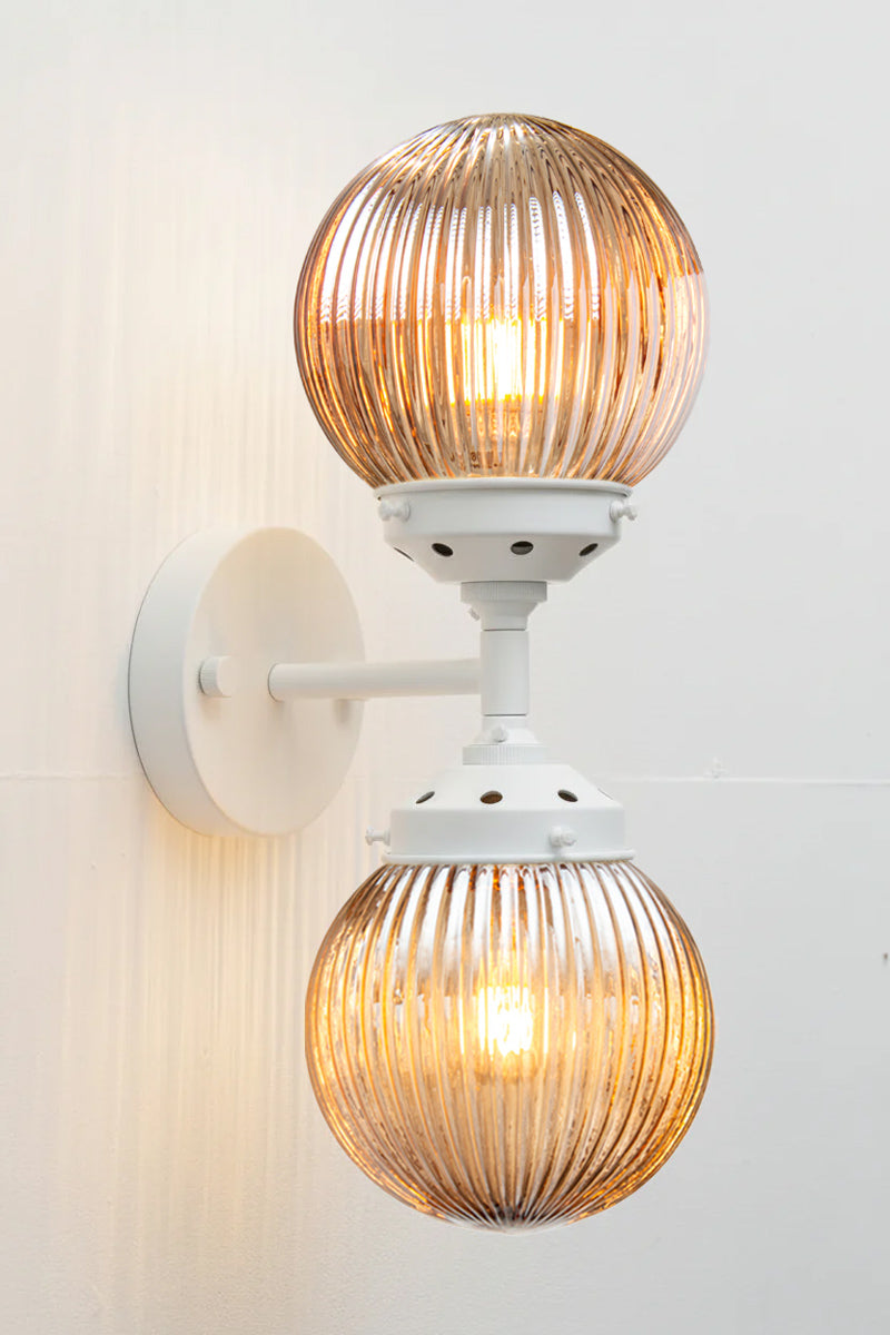 Dakota Reeded Glass Double Light on a white Wall Sconce with dark amber shades on each end