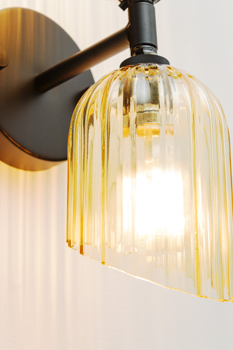 Close up of the amber glass shade with fluted detailing and angled cut design. 