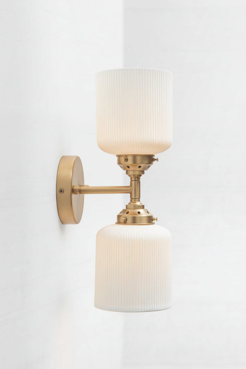 Gold/Brass double wall sconce paired with two white matt ceramic shades. 