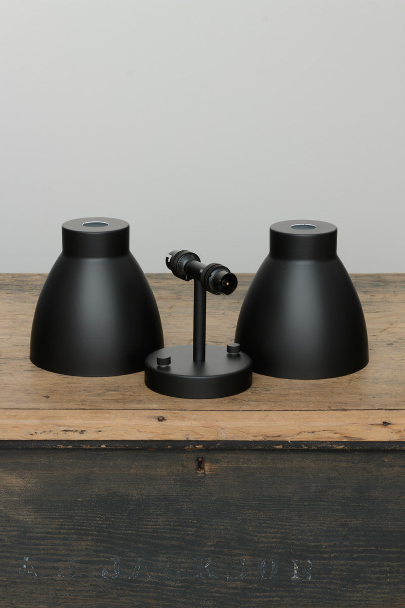 Uninstalled black double wall sconce with two black metal shades. 