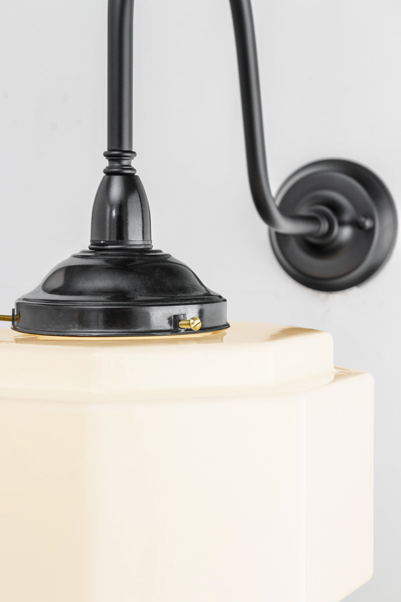 Close up of the large black gooseneck wall arm with a bakelite gallery and a stepped opal glas shade. 