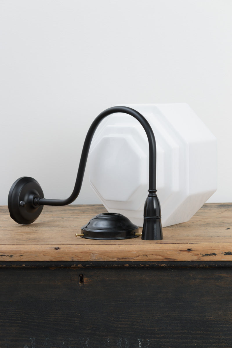 Uninstalled oversized black gooseneck wall arm with a bakelite gallery and a stepped opal glass shade.