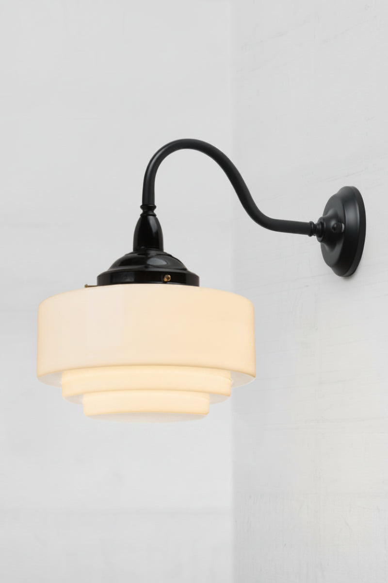 Opal glass shade with a stepped profile, paired with a matt black exterior gooseneck wall light. 