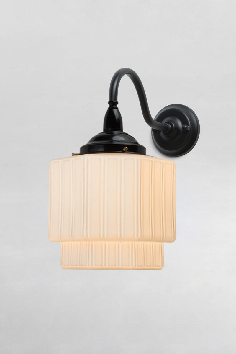 Art Deco inspired exterior wall light with an opal glass stepped shade and black gooseneck arm. 