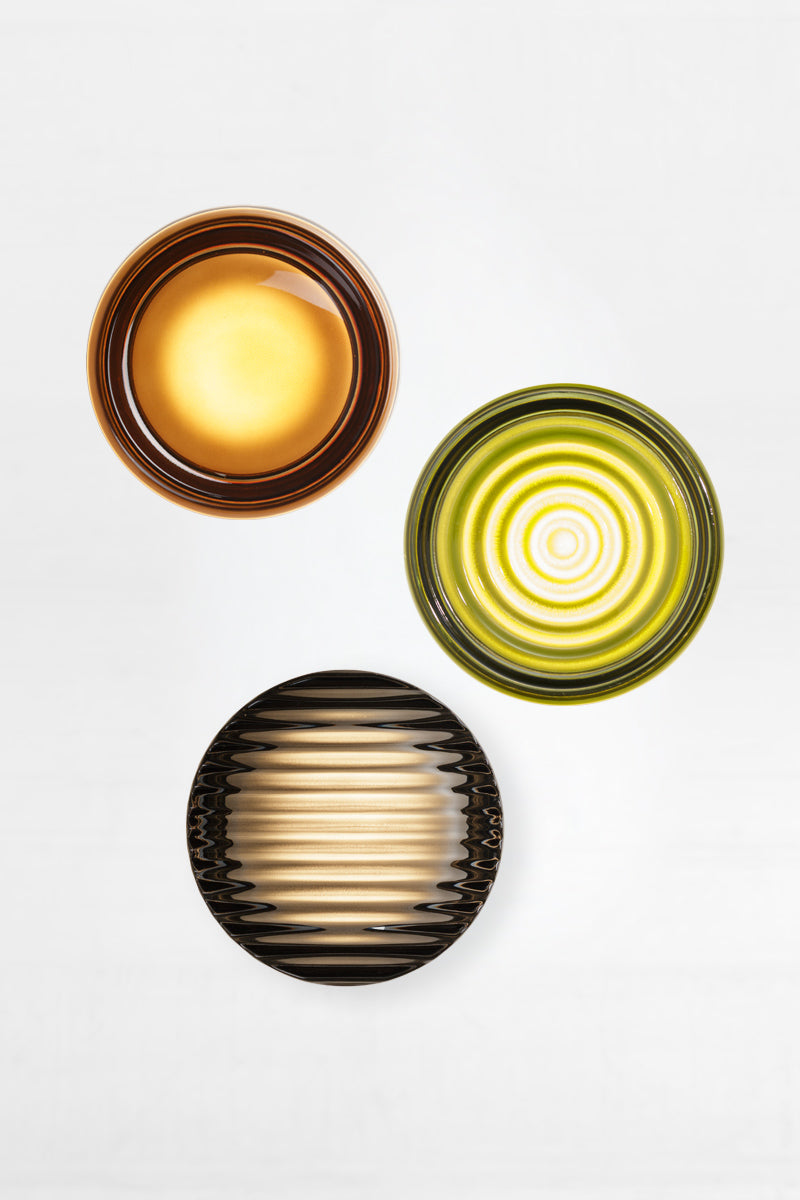Mixed glass and finish bundle of LED glass wall lights featuring an dimple amber, ripple green and saw grey glass variations in a clustered arrangement.