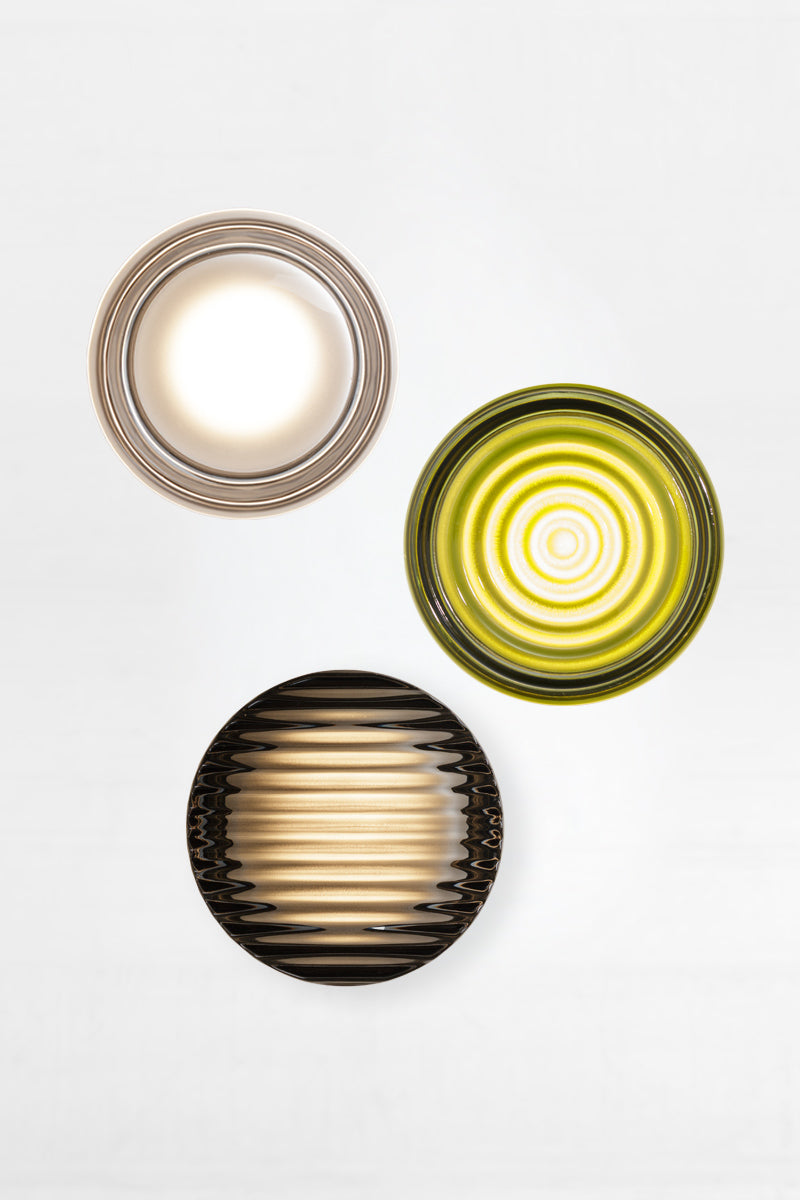 Mixed glass and finish bundle of LED glass wall lights featuring an dimple frost, ripple green and saw grey glass variations in a clustered arrangement.