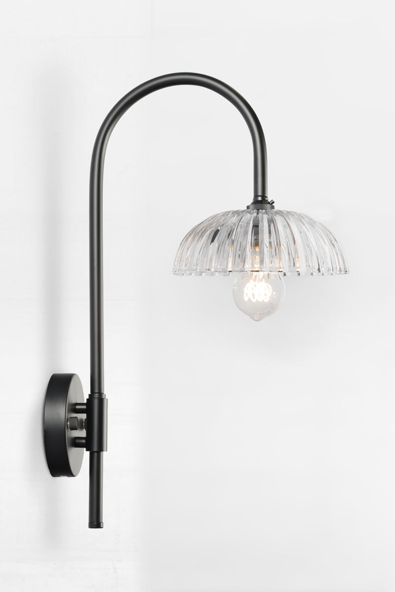 Black shepherds hook wall sconce paier with a fluted clear glass shade. 