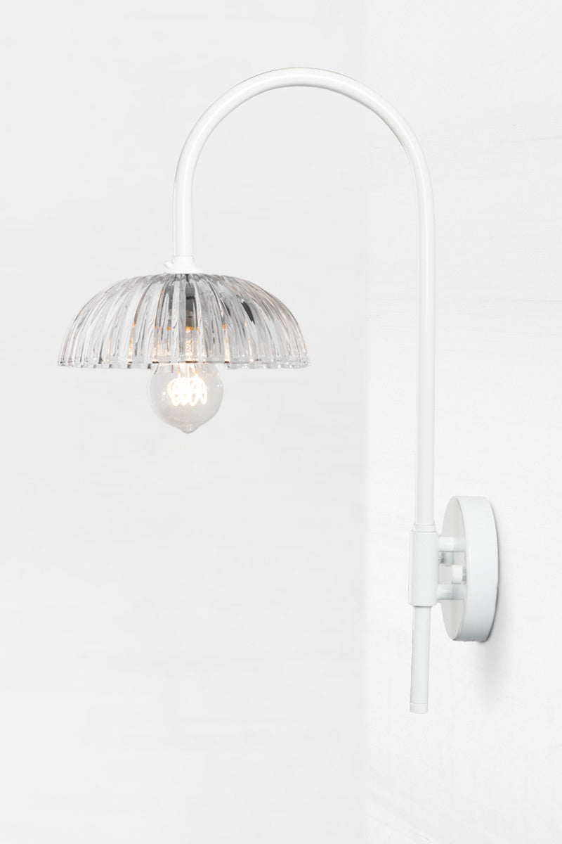 White shepherds hook wall sconce paier with a fluted clear glass shade. 