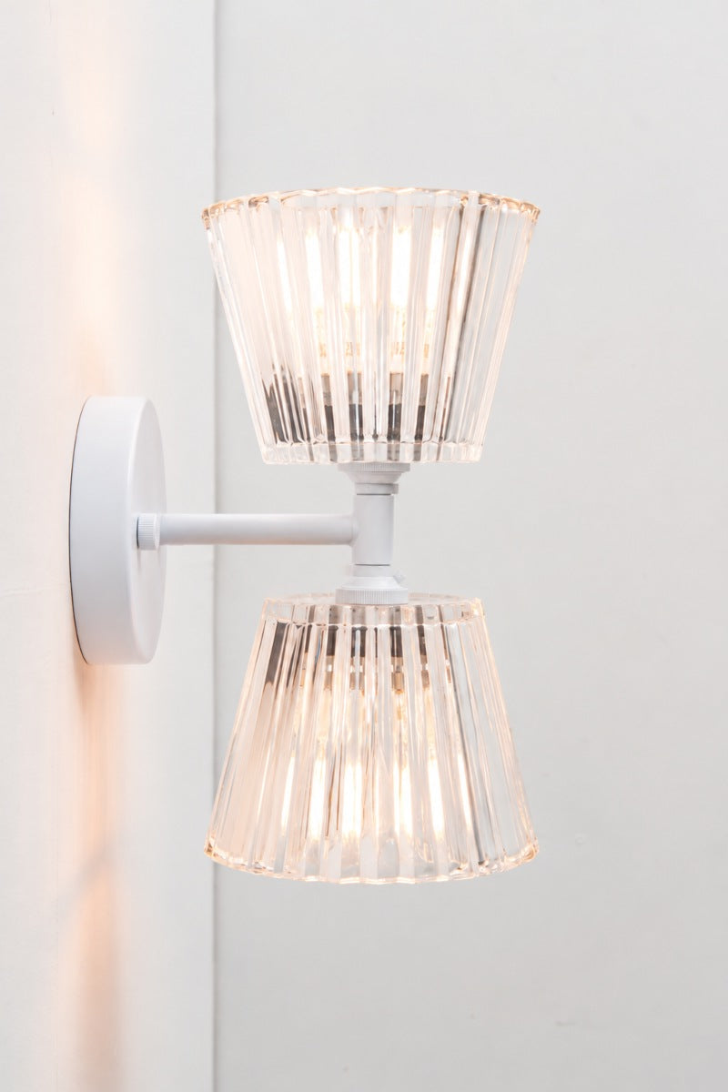 Side view of Davis Glass Double Light Wall Sconce with white fixture and clear fluted glass shades