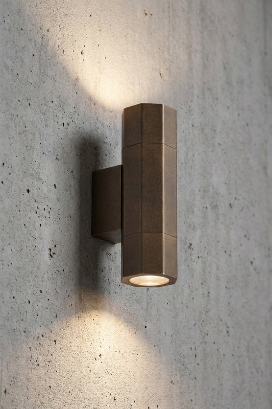 Cronulla Up Down Exterior Spotlight in aged brass, two GU10 heads casting light up and down a concrete wall, IP65