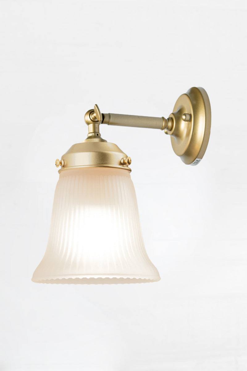 Opal glass ribbed shade wih a gold/brass short straight wall arm. 
