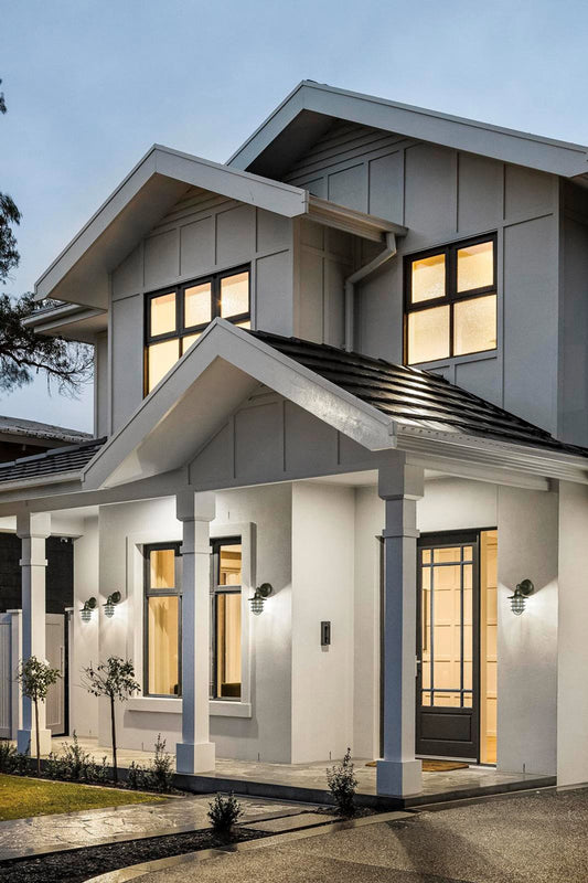 Four black caged wall lights on a black and white contemporary/traditional home. 