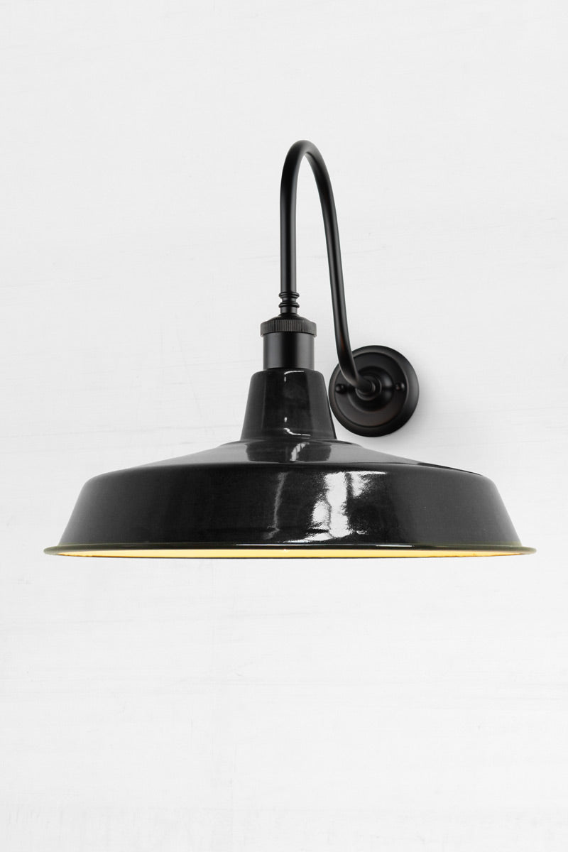 Glossy black steel shade on black arm. a stylish alternative to coach lights for any front entrance or back porch.