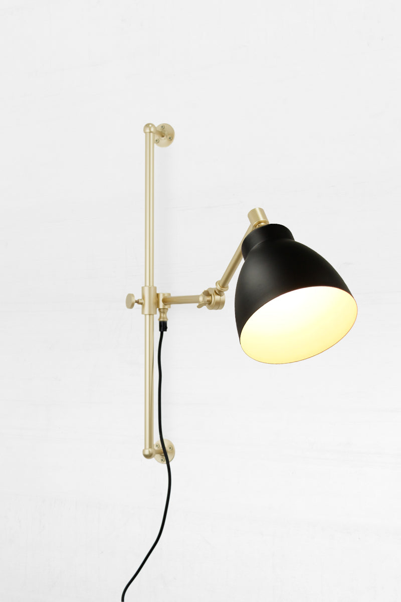 Gold brass arm with black shade and cord