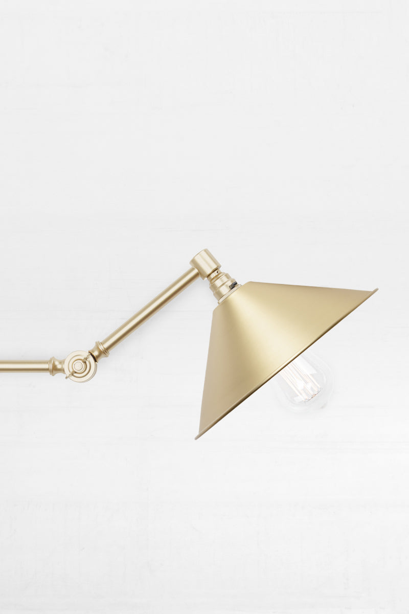 Close up of the Large bright brass shade Swing Gold/Brass Arm with Wall Plug