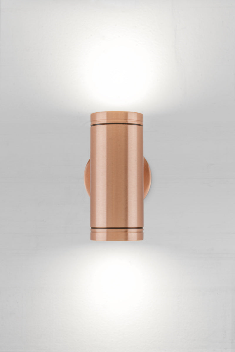 Solid copper up/down wall spot light with a polished finish. 