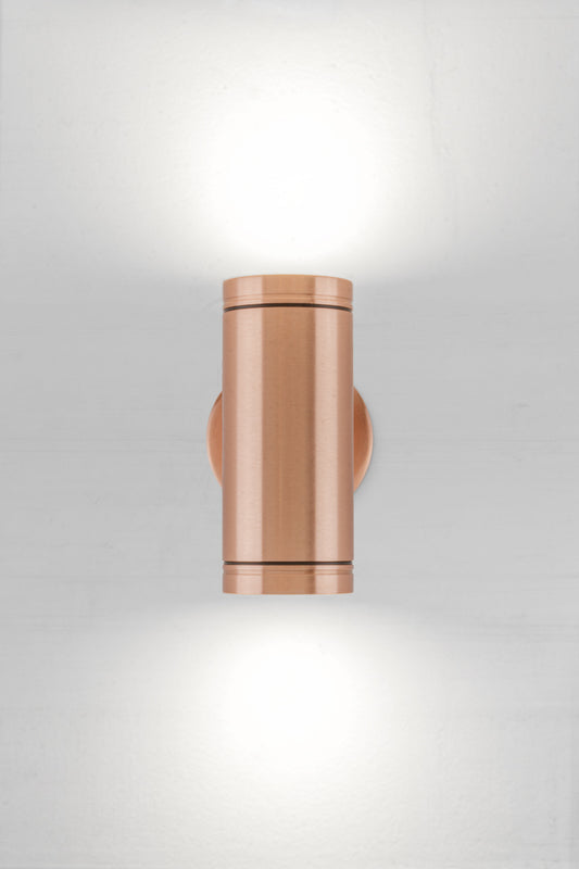 Solid copper up/down wall spot light with a polished finish. 