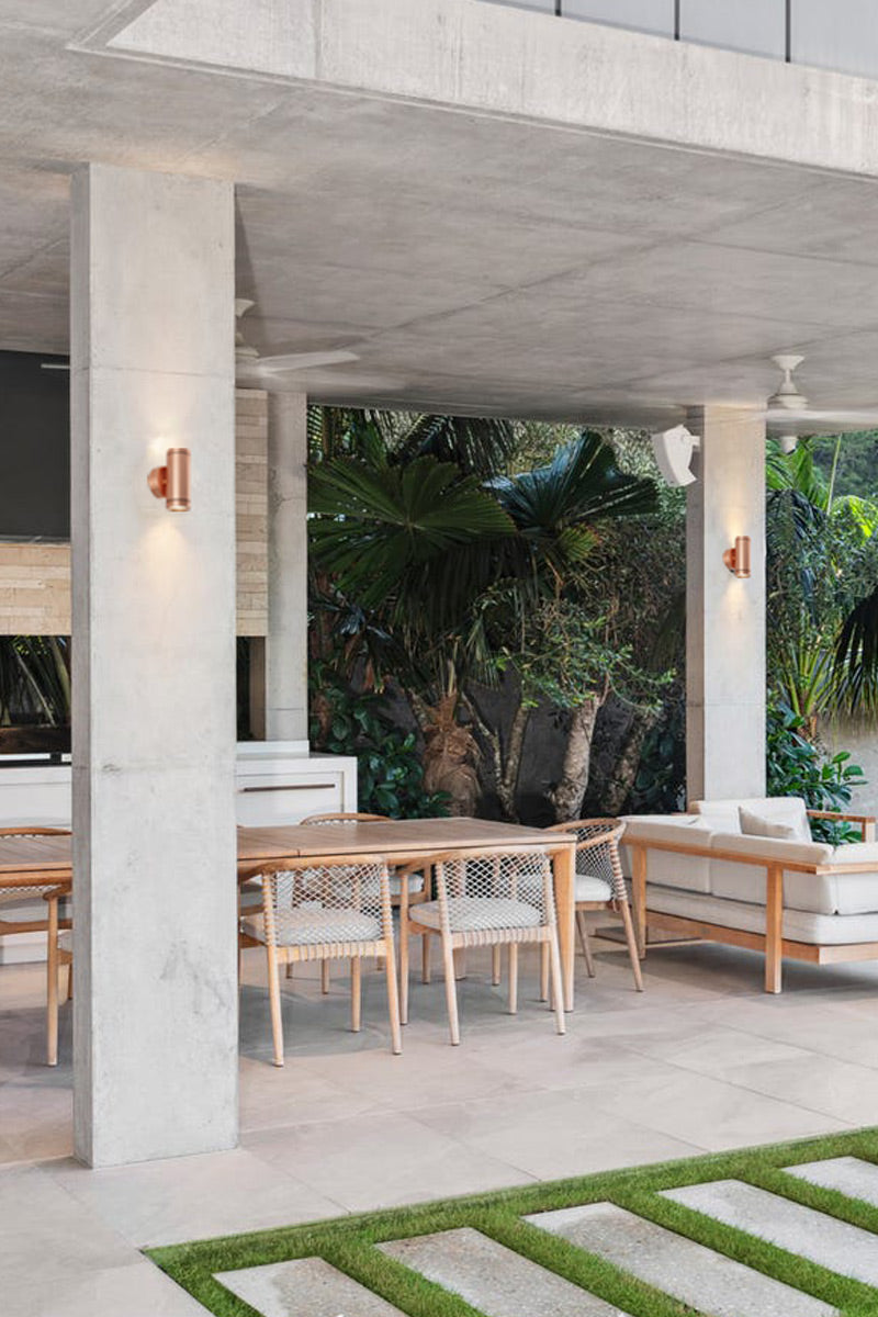 solid copper up/down wall spot light with a polished finish in outdoor entertaining area