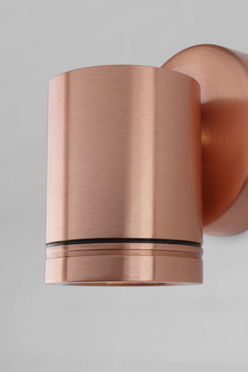 Close up of the single light solid copper outdoor spotlight with polished finish.