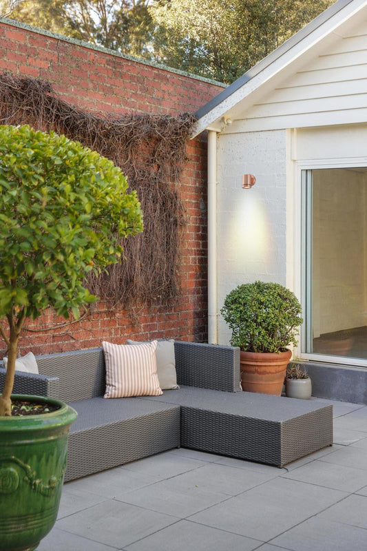 Solid copper spotlight with polished finish in outdoor patio