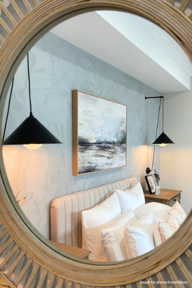 Image via @newchoicehomes: Mirror reflecting two black cone pulley pendants as bedside lights. 