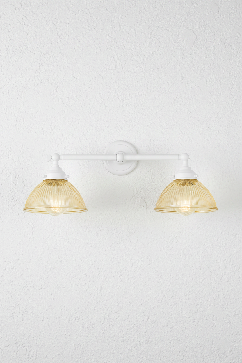 White double arm wall light with amber holophane glass shades.