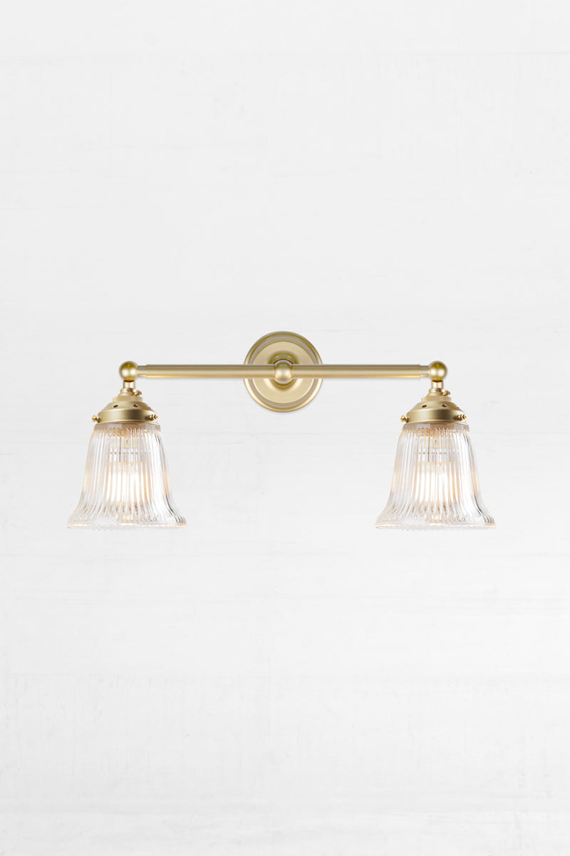 Gold/brass double arm wall light with clear glass shades