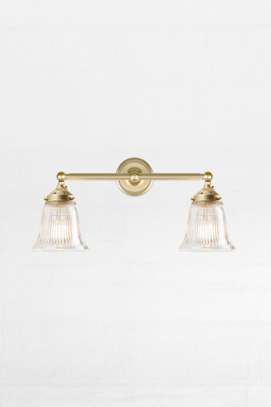Gold/brass double arm wall light with clear glass shades
