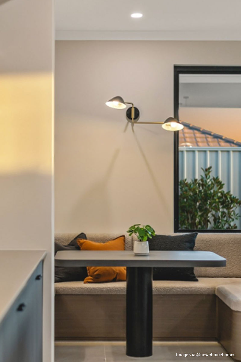 Image via @newchoicehomes: Double arm  wall light over a built in dining space. 