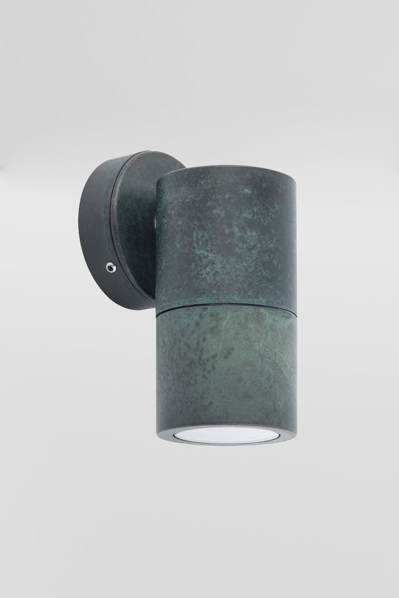 Solid brass fixed wall spotlight wih a green patina finish