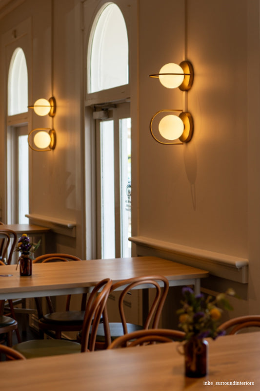 two wall lights over a dining table