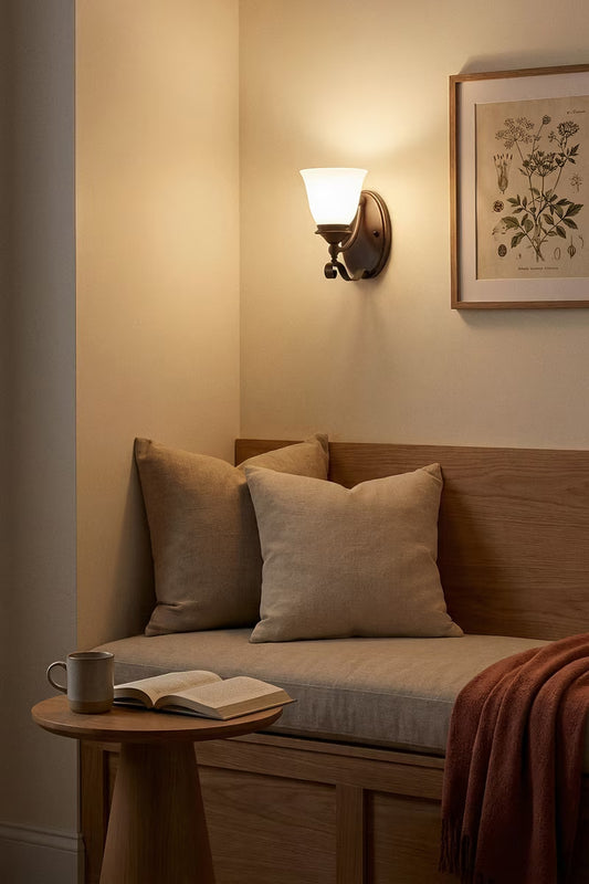 Bronze opal glass wall light over a reading nook. 
