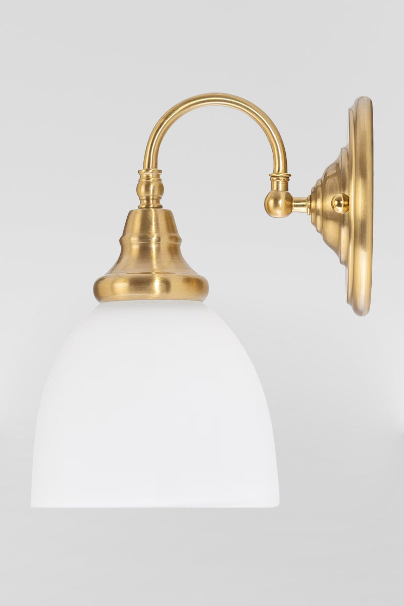 Satin Brass wall sconce with gooseneck arm facing up and an opal shade. 