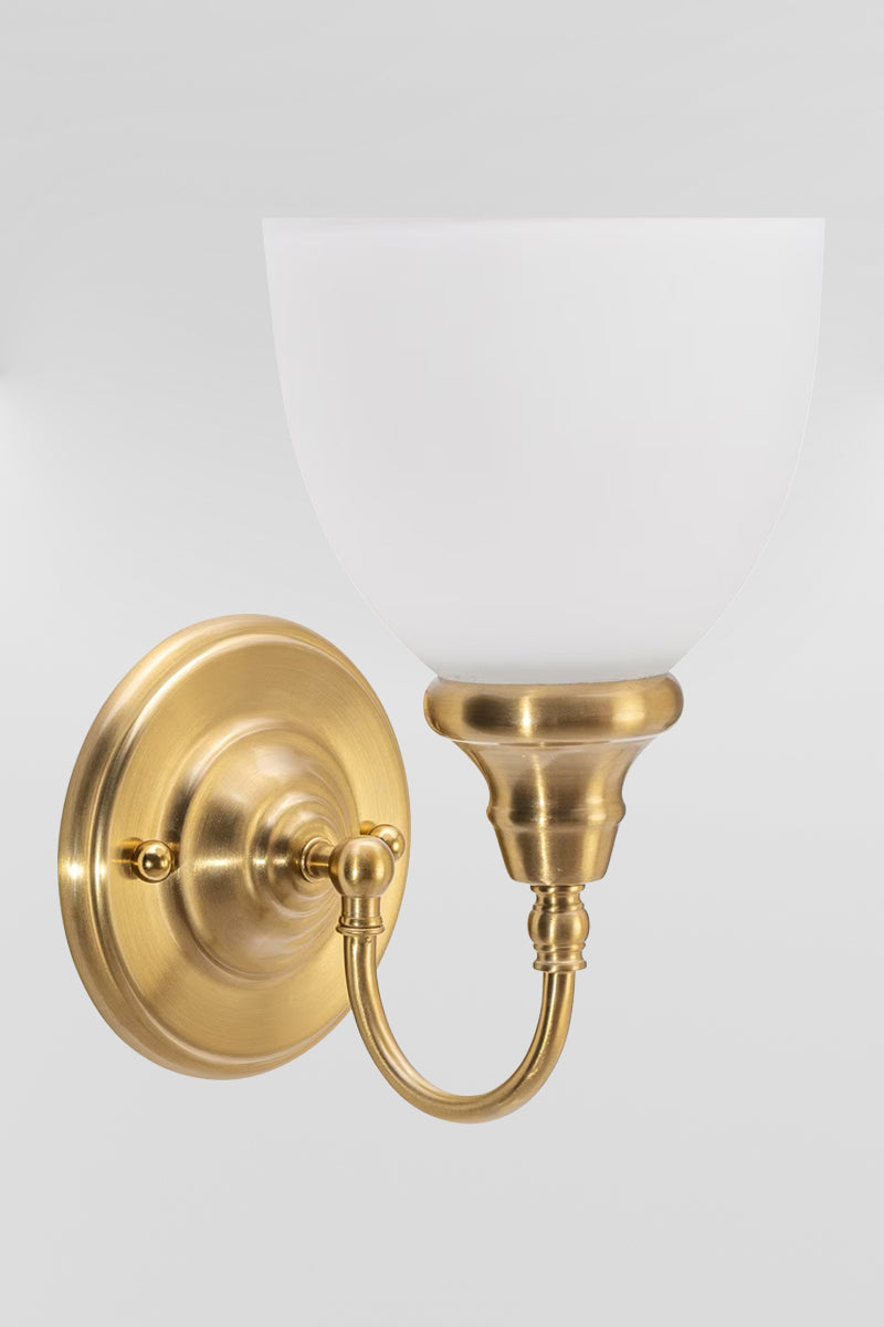 Satin Brass wall sconce with gooseneck arm and an opal shade. 