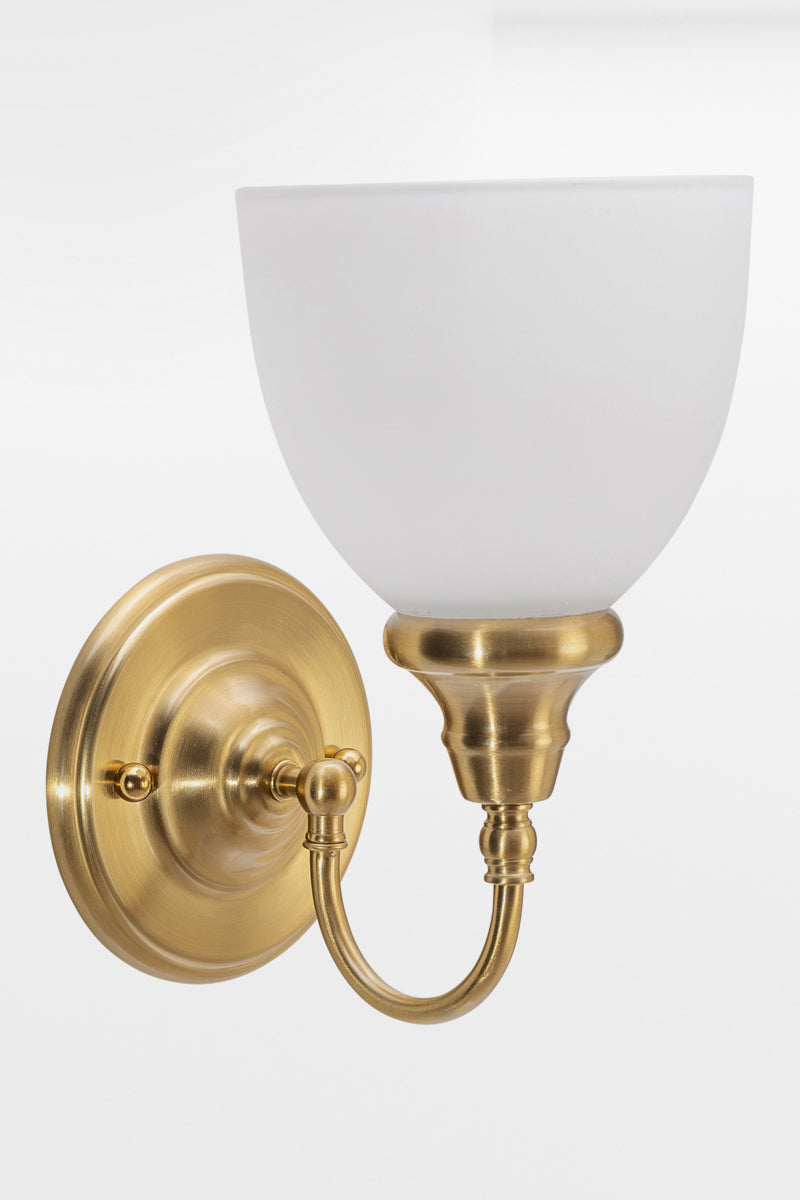Satin Brass wall sconce with gooseneck arm and an opal shade. 