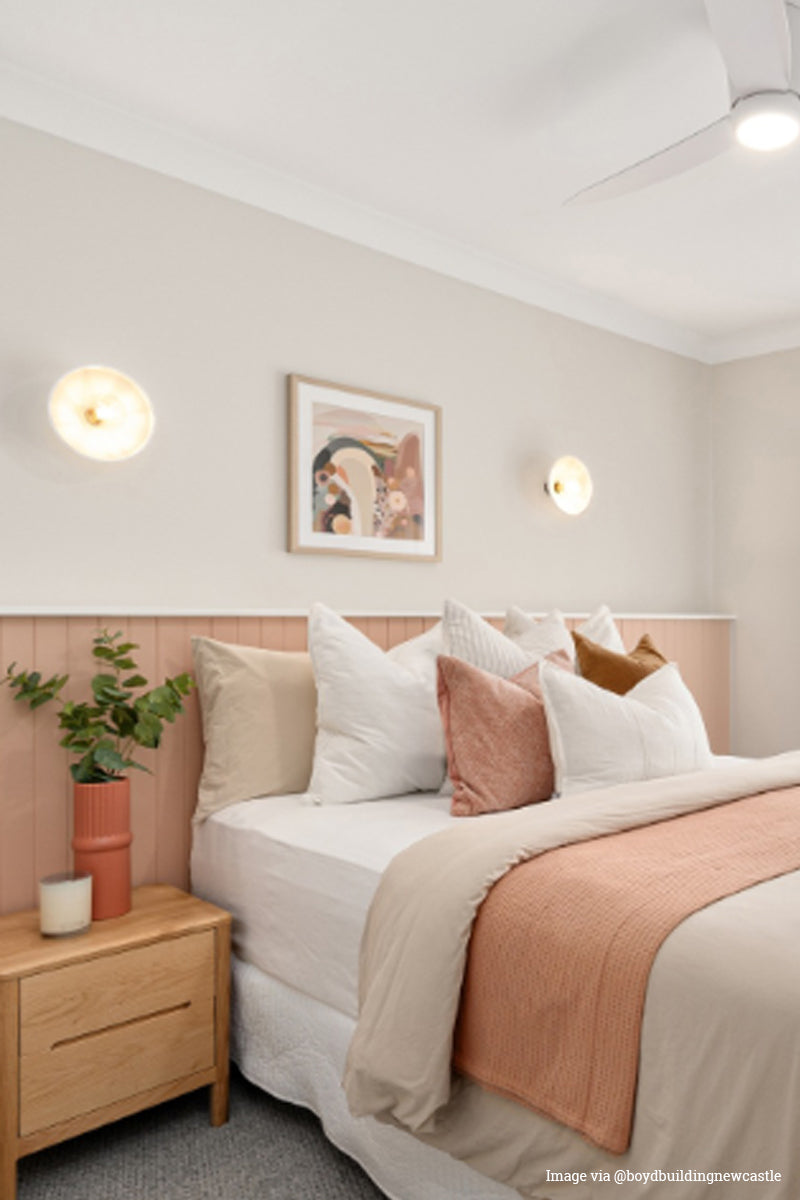 Image via @boydbuildingnewcastle Ceramic pleated shades as wall lights above a pastel bedrrom. 