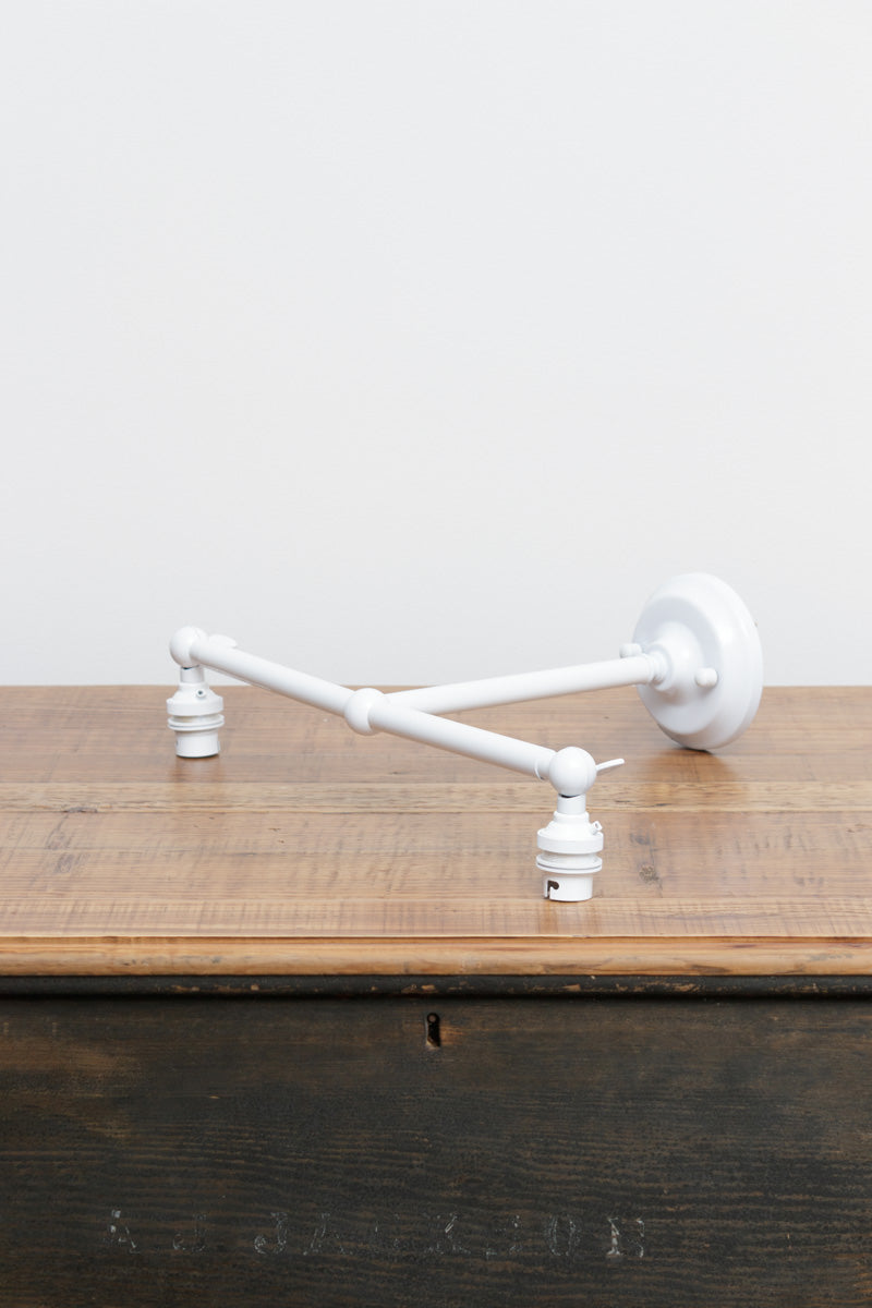 White finished double swivel lampholder wall sconce. 