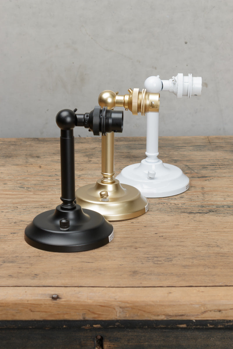 Short adjustable steel wall sconce in three finishes