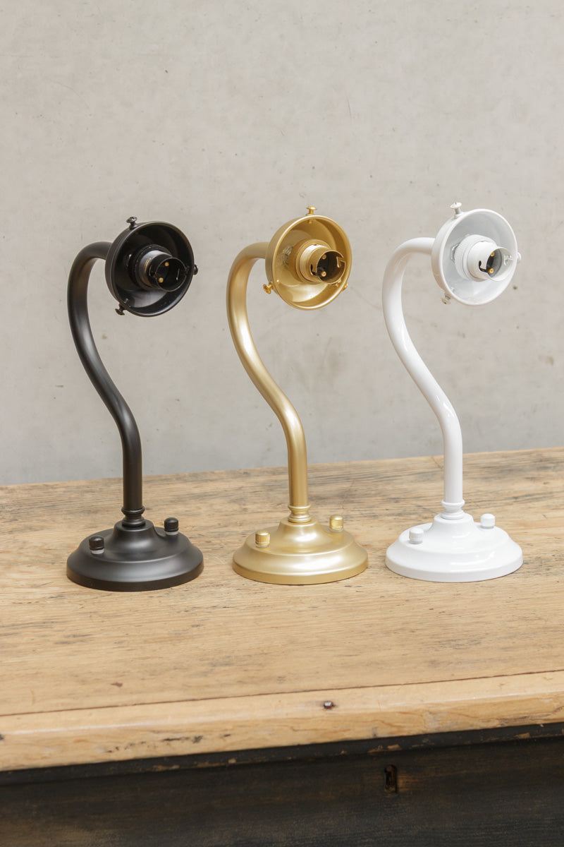 Three finishes of the outdoor wall sconce with integrated 2 1/4 inch cup. 