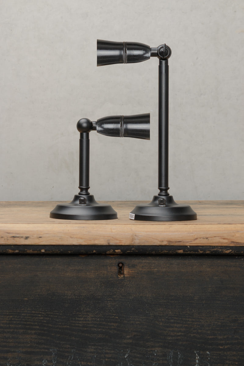Uninstalled black outdoor wall stonce in black with a short vs long straight arm. 