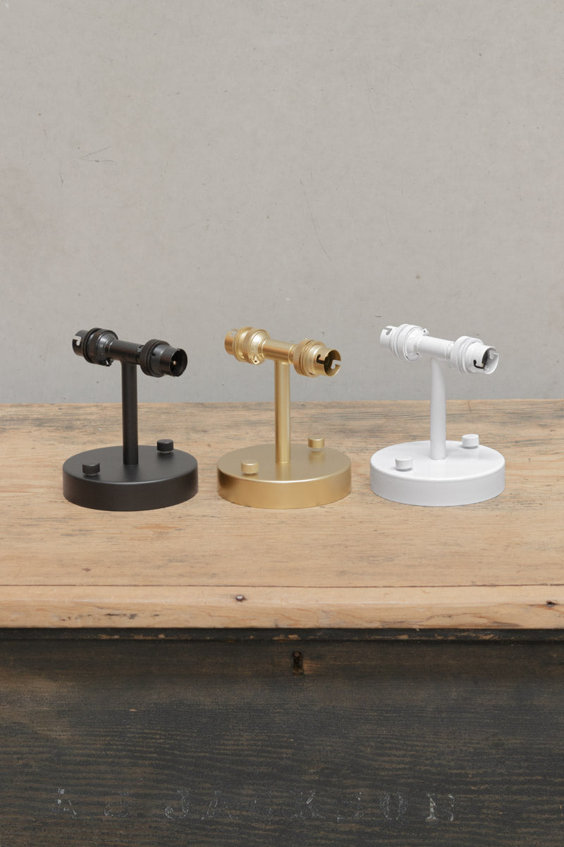 Three steel double wall sconces in black, gold, and white