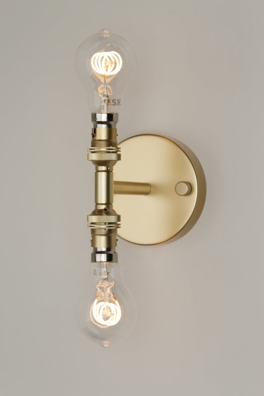 Gold/Brass Double Wall Sconce Light, paired with clear A60 bulbs.