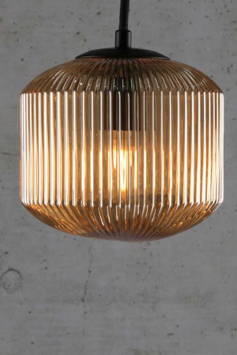 Amber reeded glass shade with black 9 drop multi cord. 