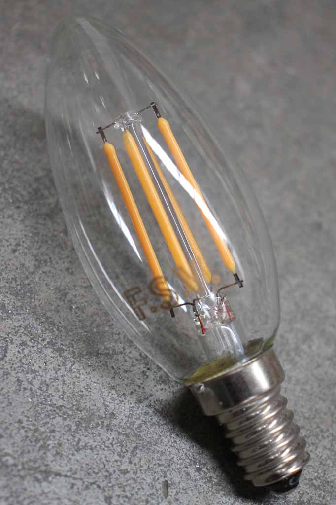 Vintage style filament LED candle bulb showing the glass tip and filaments