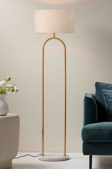 Floor Lamp in Satin Brass with a White Marble base and Flax Linen Shade in a Living Room