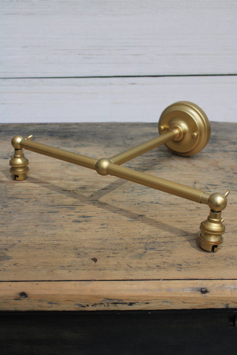 Gold finish double arm wall sconce