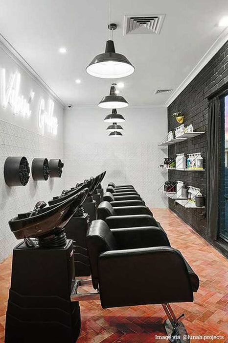 5 large station pendant lights in a hair salon. 