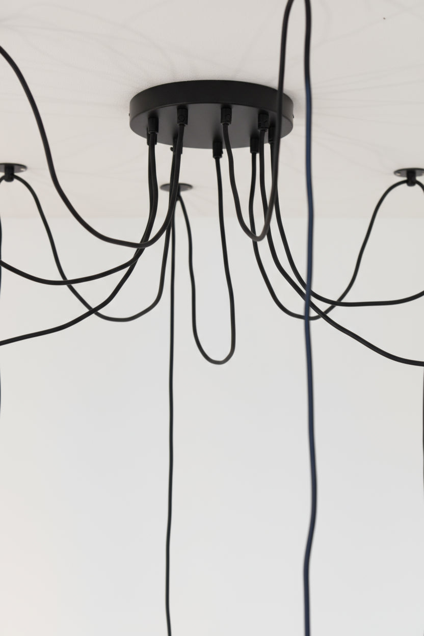 Close up of the ceiling rose of the 9 drop chandelier with plates. 